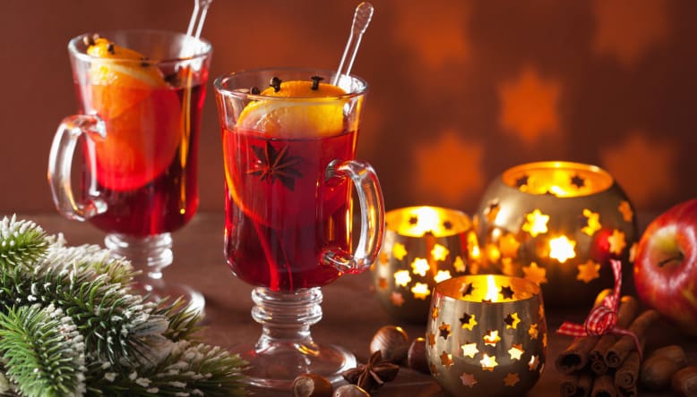 glass of mulled wine with orange and spices, christmas decoratio